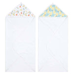 The aden + anais essentials cotton muslin hooded towels 2 pack features super absorbent white towels. The left towel has a fruit pattern with oranges and peaches inside the hood, while the right displays vibrant lemons on a blue background. Crafted from plush cotton terry for ultimate comfort.