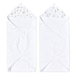 Two aden + anais essentials cotton muslin hooded towels are featured, each absorbent and plush. One towel has a pink floral lining and the other with gray animal patterns, both laid flat with hoods at the top.