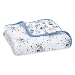 The aden + anais Disney™ essentials cotton muslin dream blanket has a cartoon and star pattern on a white background with a light blue border, ideal for tummy time adventures.