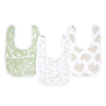 The essentials cotton muslin snap bibs 3 pack by aden + anais offers style and practicality with three absorbent bibs: green with a forest animal pattern, white with light animal sketches, and white with beige leaf designs. Designed to grow with your baby.
