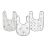 Three essentials cotton muslin snap bibs from aden + anais are shown, crafted from absorbent cotton muslin. Each light-colored bib has gray trims: one is plain, another with gray stars, and the third has gray polka dots, designed for growing convenience and comfort.
