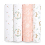 The aden + anais essentials cotton muslin swaddle blanket 4 pack includes soft, breathable fabric with whimsical designs like small flowers, rabbits in a wreath, hand-drawn roses on peach, and rabbits with leaves.