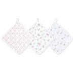 The aden + anais essential cotton muslin washcloths 3 pack includes three soft, square cloths with hanging loops; one in pink checkers, another in floral, and the last featuring charming small animals on absorbent layers—ideal for delicate skin.