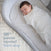 A baby sleeps peacefully in a gray bassinet, swaddled in the HALO Swaddle 100% Cotton TOG 1.5 with adjustable wings. Text on the image reads: 98% of parents reported better sleep.
