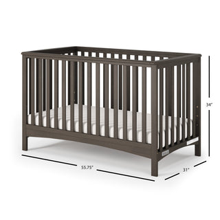 The Child Craft London 2-Piece Nursery Set features a dark wooden 4-in-1 convertible crib with vertical slats, a white mattress, and measures 55.75"L x 31"W x 34"H—perfect for any nursery.