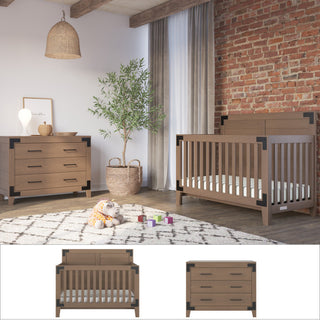 A cozy nursery with exposed brick, wood beams, a geometric rug, toys, plants, warm lighting, and the Child Craft Lucas 2-Piece Nursery Set featuring a modern farmhouse crib and dresser with black corner accents.