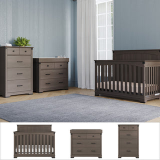 A nursery furnished with the Child Craft Redmond 4 Piece Nursery Set—crib, dresser with changing tray, and chest—sits on a light wood floor with a gray rug. Light blue walls and a large window with white curtains fill the room with natural light.