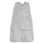 The HALO Swaddle 100% Organic Cotton TOG 1.5 in light gray features a front zipper, adjustable wings for a secure fit, soft fabric for comfort, and the HALO logo on the chest.