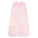 The HALO Swaddle 100% Organic Cotton TOG 1.5 is a light pink, sleeveless swaddle with crossover panels, a bottom zipper, and HALO branding—offering adjustable comfort and convenience for your baby.