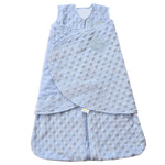 The HALO Swaddle Plushy Dot Velboa TOG 3.0 is a soft, light blue wearable baby blanket with a sleeveless, 3-in-1 design. It features a textured dot pattern, zipper, and wrap-around closure for healthy hip development, along with an embroidered logo on the chest for added charm.