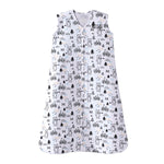 The HALO Wearable Blanket 100% Cotton TOG 0.5 is a sleeveless white sleep sack with a front zipper, featuring an adorable black-and-white animal pattern of penguins, bears, and trees, accented with small orange and blue dots to promote safe sleep for your little one.