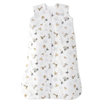 The HALO Wearable Blanket Cotton TOG 0.5 is a white sleeveless sleep sack with a front zipper, featuring adorable bear, elephant, giraffe, and leaf prints in soft beige and grey tones for safe sleep.