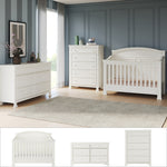 A modern nursery featuring the Child Craft Westgate 3-Piece Nursery Set with Crib, Dresser, and Chest arranged on a beige rug, set against blue paneled walls with large windows and contemporary art.